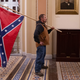 Image for article titled FBI Narrows Down Identity Of Red-Faced Man Carrying Confederate Flag Through Capitol To Millions Of Americans